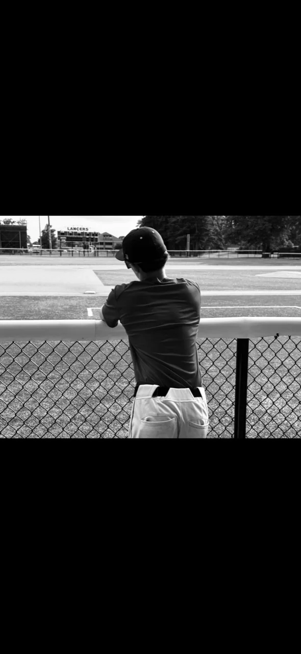 Black-and-white baseball scene at the fence